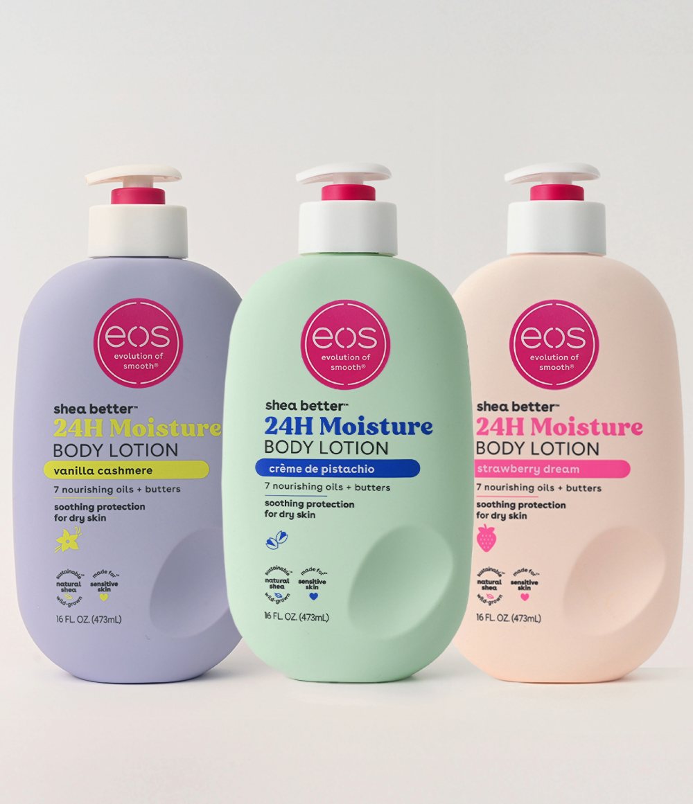 Three bottles of eos body lotion in purple, green, and pink on a white background
